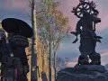 Samuraj przy Kapliczce Popiołów w Ghost of Tsushima. W tle posąg Buddy i drzewa.