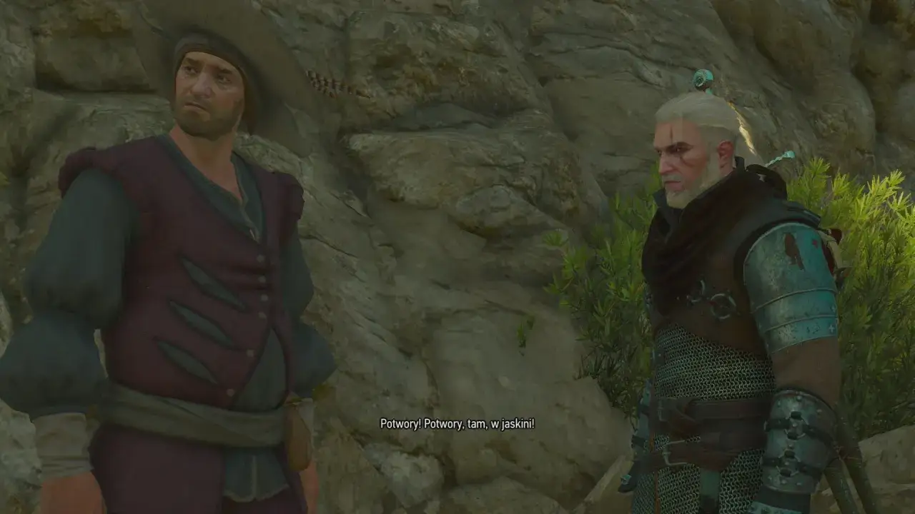 Geralt i jego towarzysz rozmawiają o potworach w jaskini. To scena z Wiedźmin 3, gdzie braterska miłość jest wystawiana na próbę.