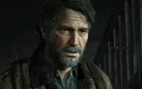 Zmęczony Joel z blizną na policzku, w brązowej kurtce, wygląda jakby czekał na wydarzenia z The Last of Us 3.