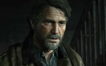 Zmęczony Joel z blizną na policzku, w brązowej kurtce, wygląda jakby czekał na wydarzenia z The Last of Us 3.